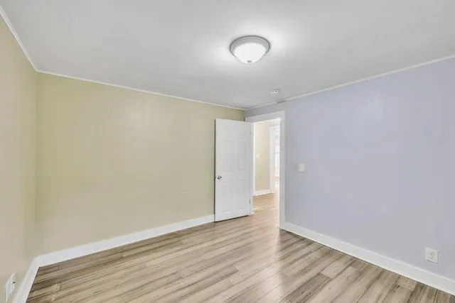 a view of a yard in front of a house with large trees