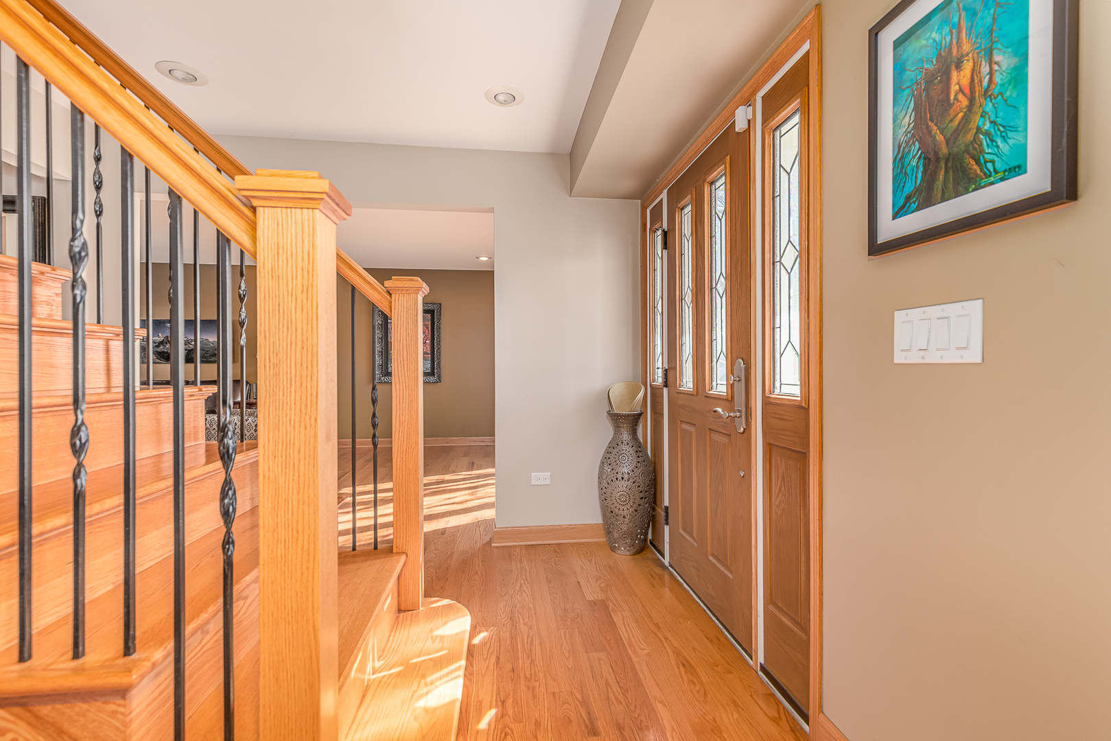 181 Queenswood Road Bolingbrook, IL 60440 - Photo 6 of 46 a view of a hallway with wooden floor and staircase