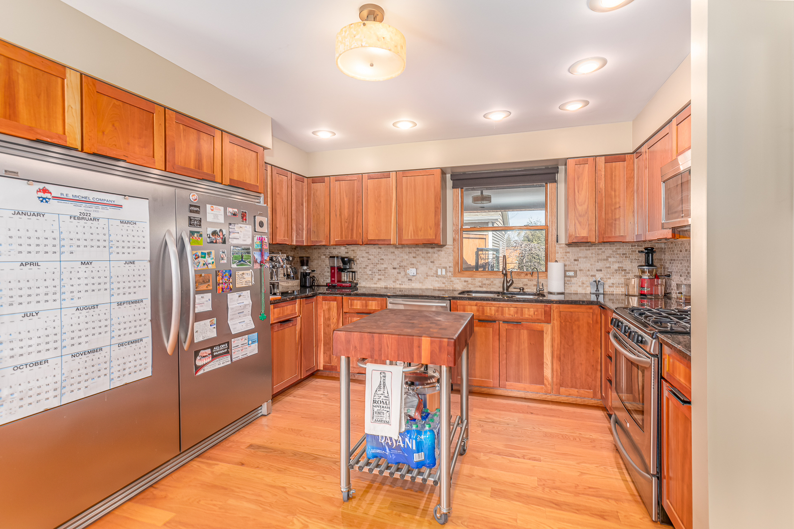 181 Queenswood Road Bolingbrook, IL 60440 - Photo 10 of 46 a large kitchen with stainless steel appliances granite countertop a stove a sink and a refrigerator