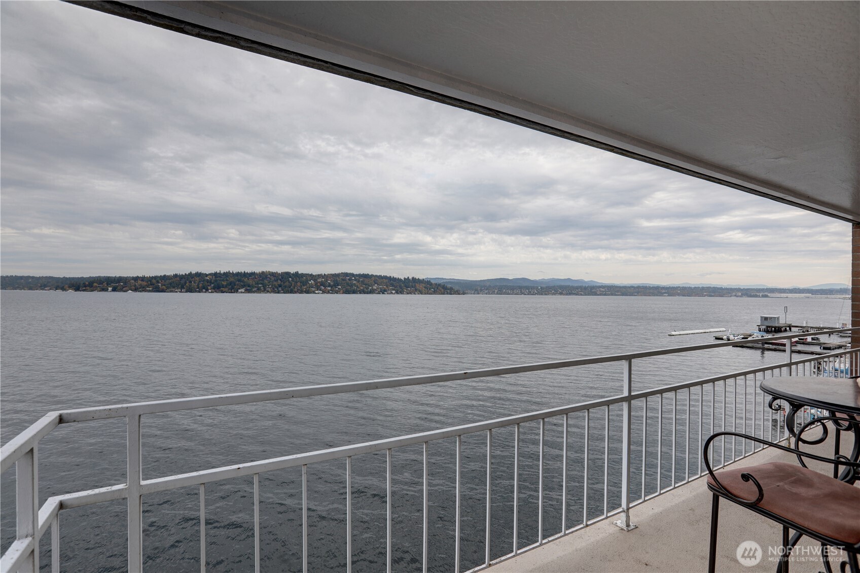 a view of a balcony with wooden floor and fence