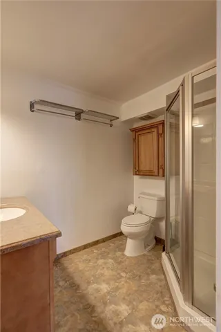 a bathroom with a toilet a sink and a shower