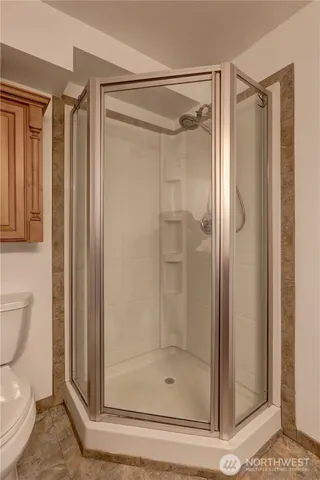 a bathroom with a shower and a toilet