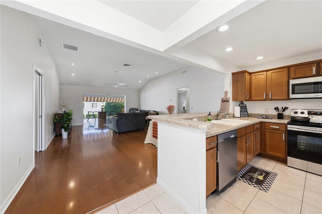 2241 Hackney Way The Villages, FL 32162 - Photo 11 of 50 a kitchen with stainless steel appliances kitchen island granite countertop a sink and cabinets