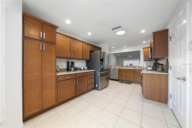 a kitchen with stainless steel appliances granite countertop a refrigerator sink and cabinets