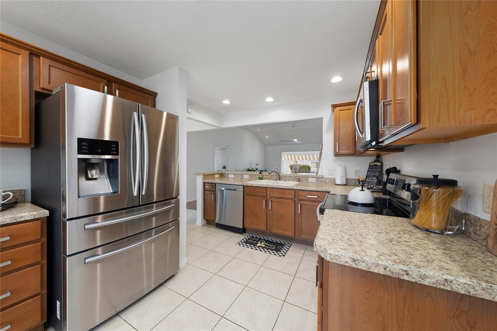 2241 Hackney Way The Villages, FL 32162 - Photo 13 of 50 a kitchen with a sink refrigerator and microwave