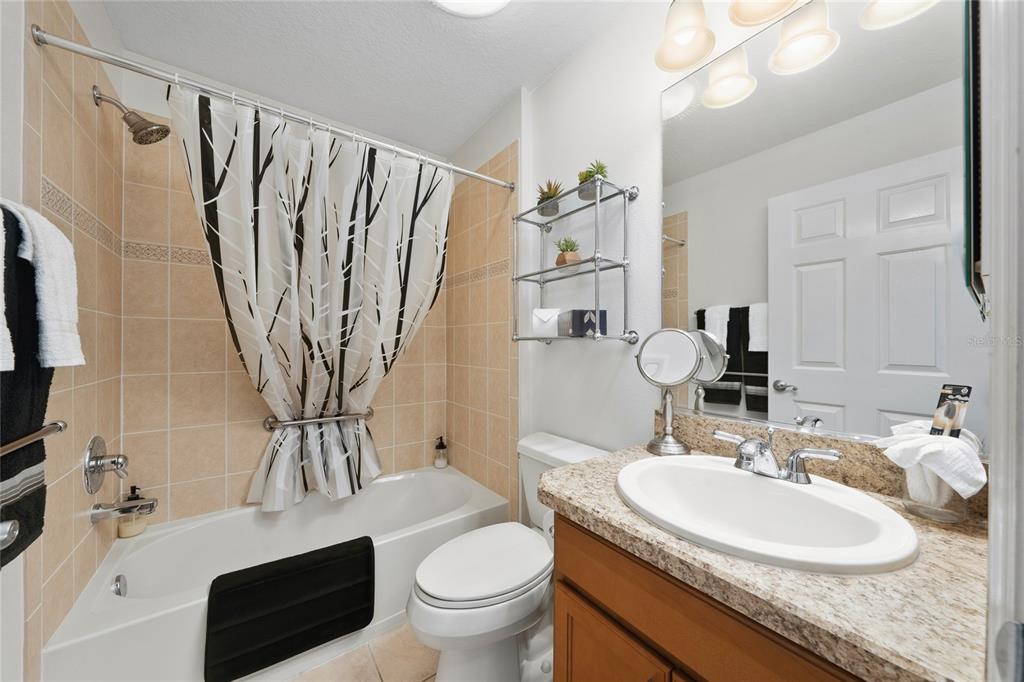2241 Hackney Way The Villages, FL 32162 - Photo 26 of 50 a bathroom with a granite countertop sink toilet and shower