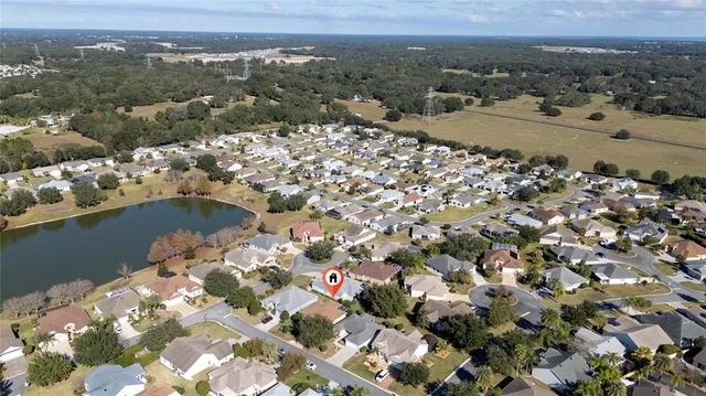 an aerial view of a house with a yard