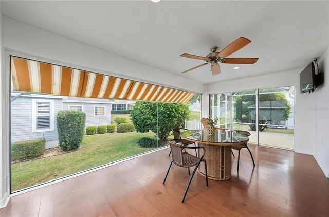 a view of a dining room with furniture window and wooden floor