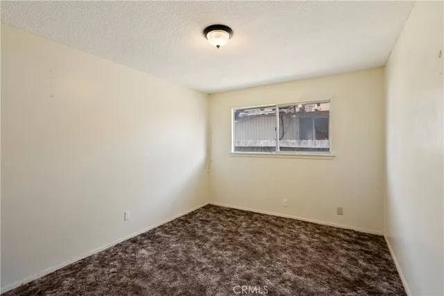 a view of a room with wooden floor and a window