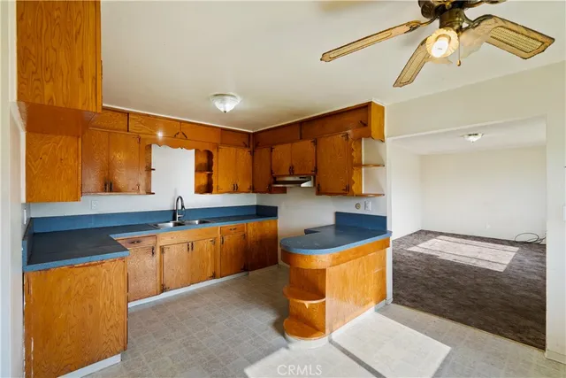 a kitchen with stainless steel appliances granite countertop a sink and cabinets