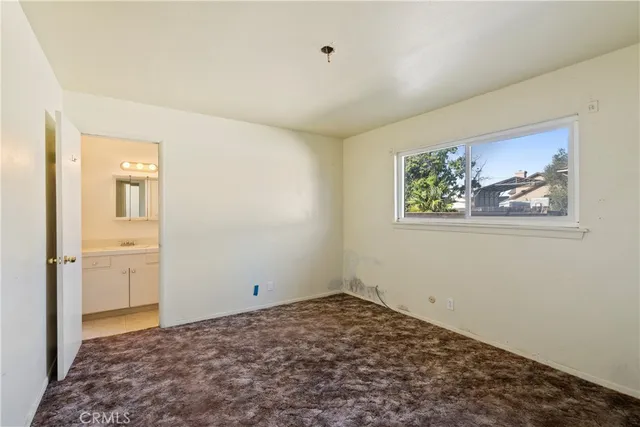 a view of a bedroom with wooden floor and closet