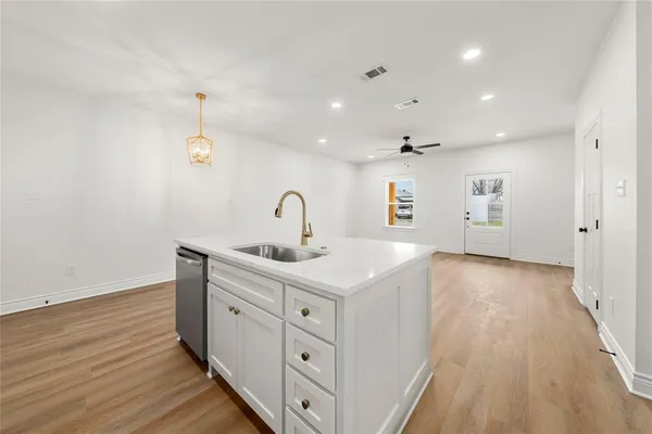 a kitchen with a sink and chandelier
