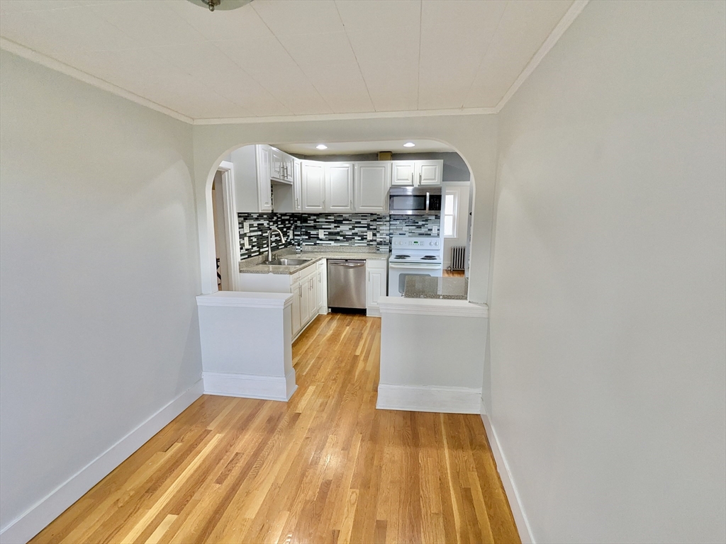 161 Webster Street, Unit 2 Malden, MA 02148 - Photo 5 of 15 a kitchen with a sink and a refrigerator