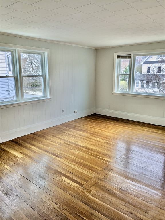 161 Webster Street, Unit 2 Malden, MA 02148 - Photo 7 of 15 a view of an empty room with wooden floor and a window