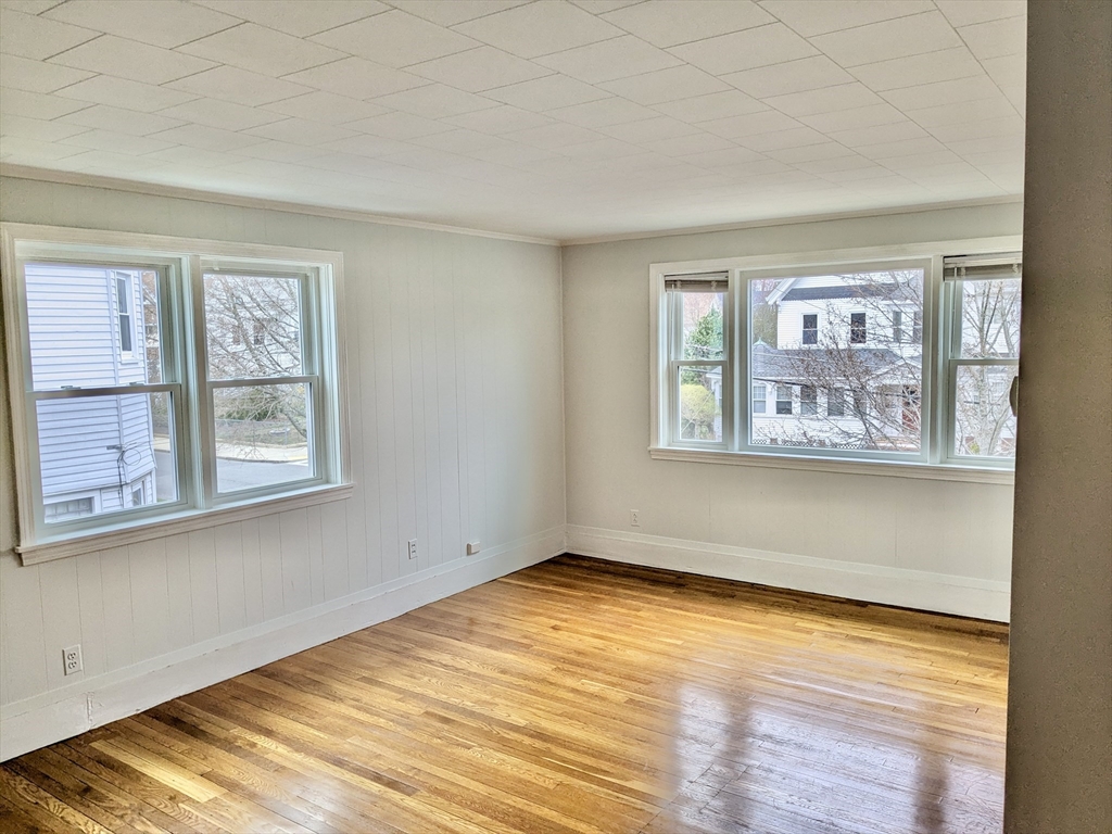 161 Webster Street, Unit 2 Malden, MA 02148 - Photo 8 of 15 a view of empty room with window and wooden floor