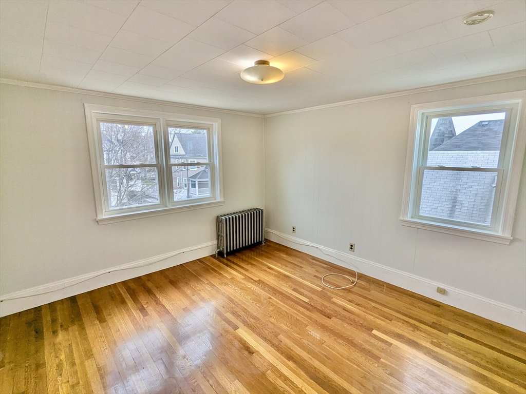 161 Webster Street, Unit 2 Malden, MA 02148 - Photo 10 of 15 a view of an empty room with a window and wooden floor