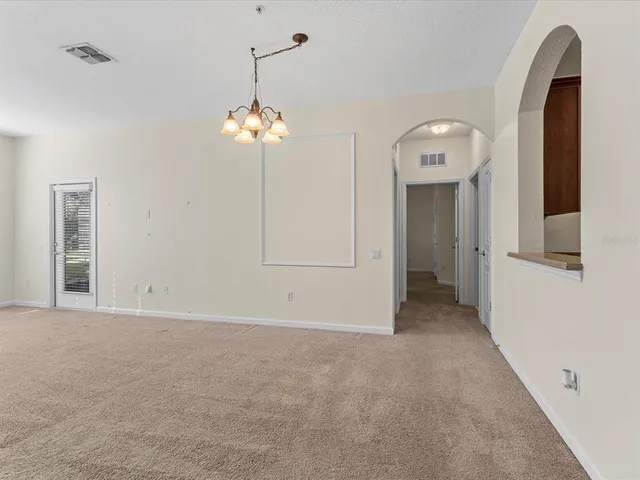 a view of a chandelier fan and entryway