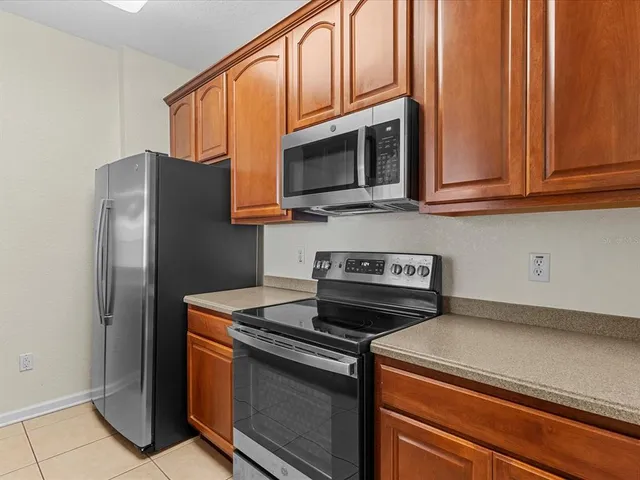 a kitchen with stainless steel appliances granite countertop a refrigerator stove and microwave