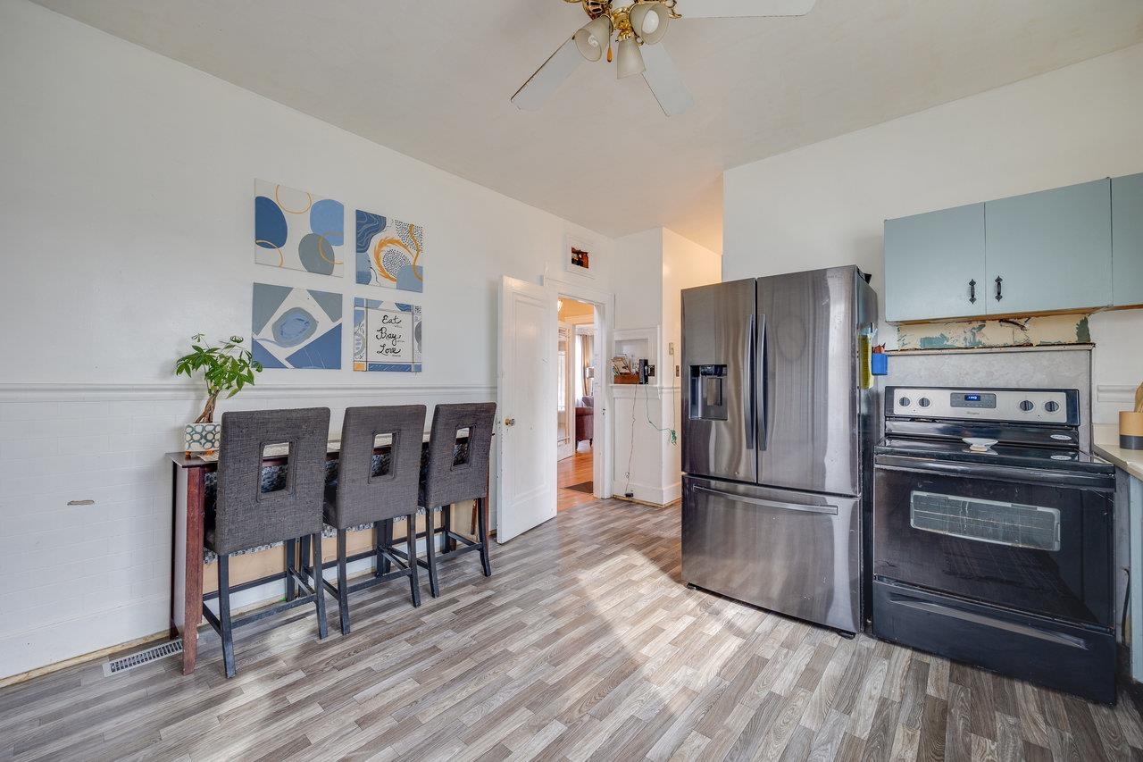 515 Fourth Street Shenandoah, VA 22849 - Photo 15 of 51 a kitchen with granite countertop a refrigerator dining table and chairs