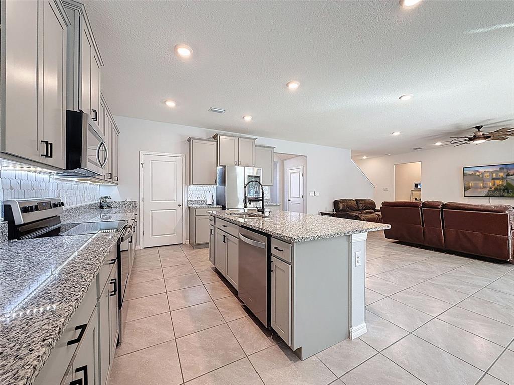 3797 Autumn Amber Dr Spring Hill Spring Hill, FL 34609 - Photo 11 of 44 a large kitchen with stainless steel appliances lots of counter top space
