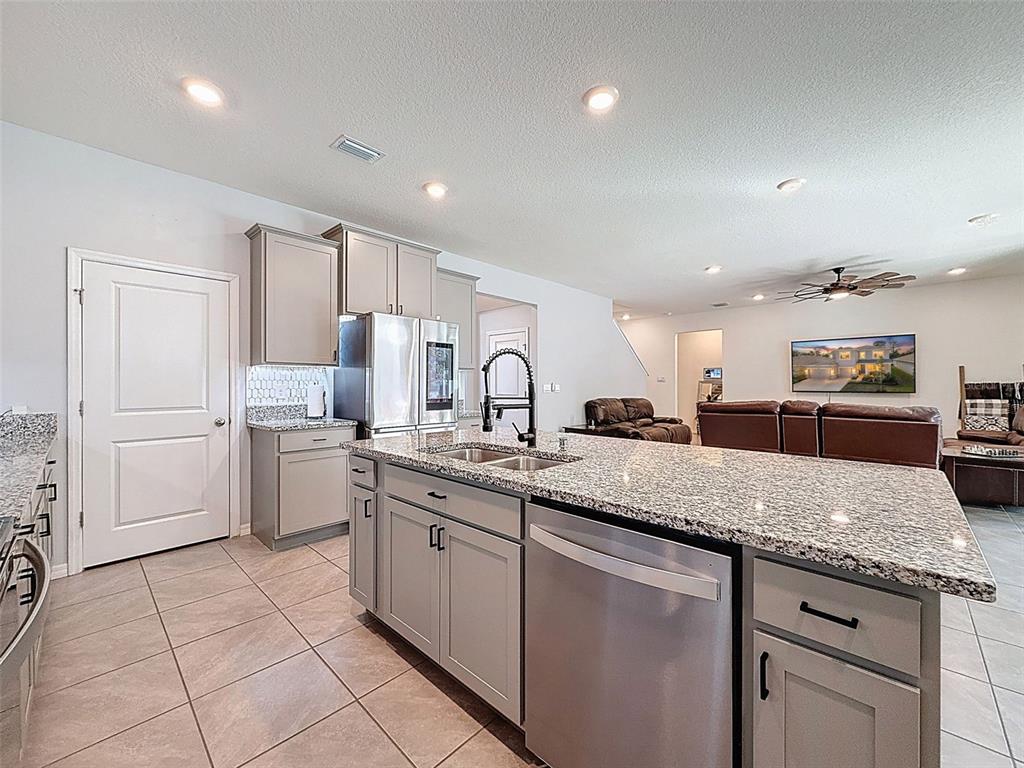 3797 Autumn Amber Dr Spring Hill Spring Hill, FL 34609 - Photo 13 of 44 a kitchen with sink and white cabinets