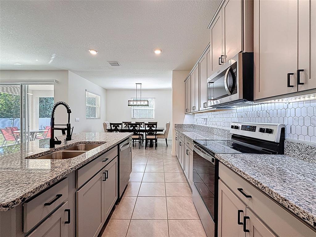3797 Autumn Amber Dr Spring Hill Spring Hill, FL 34609 - Photo 15 of 44 a kitchen with sink stove and cabinets