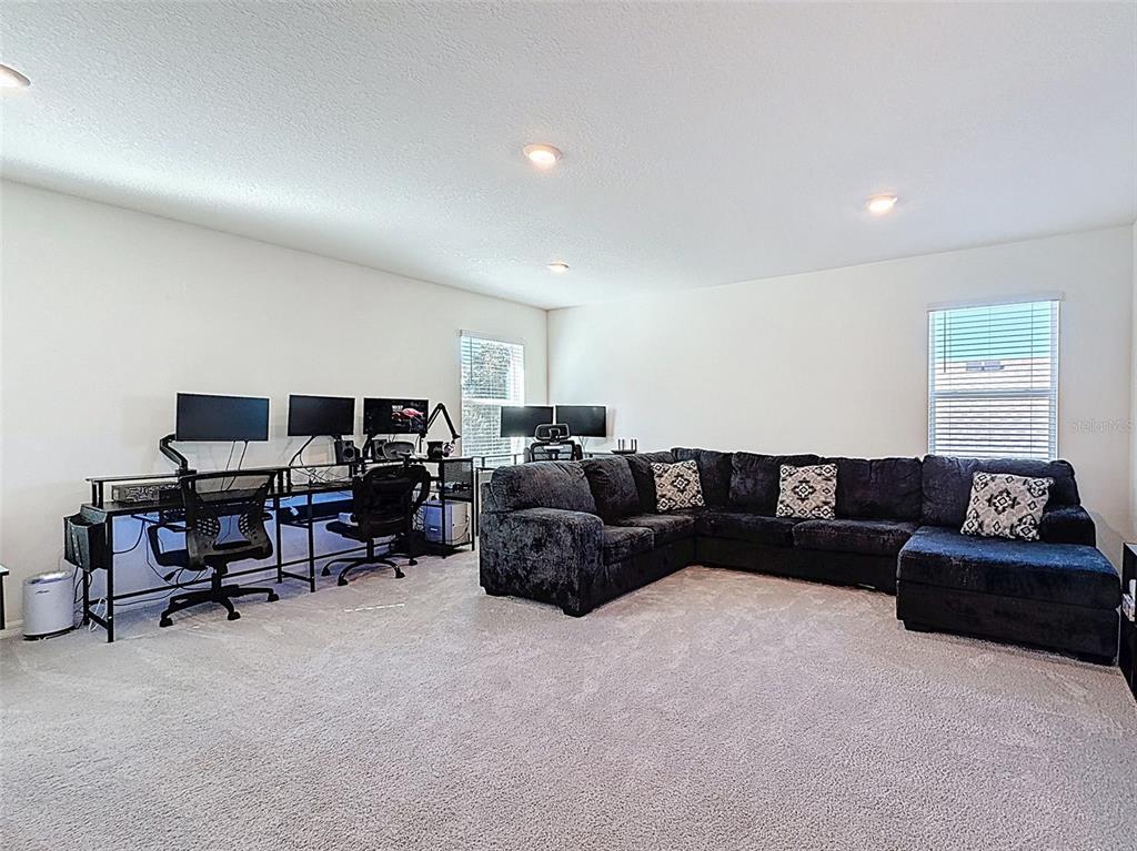 3797 Autumn Amber Dr Spring Hill Spring Hill, FL 34609 - Photo 20 of 44 a living room with furniture and a flat screen tv