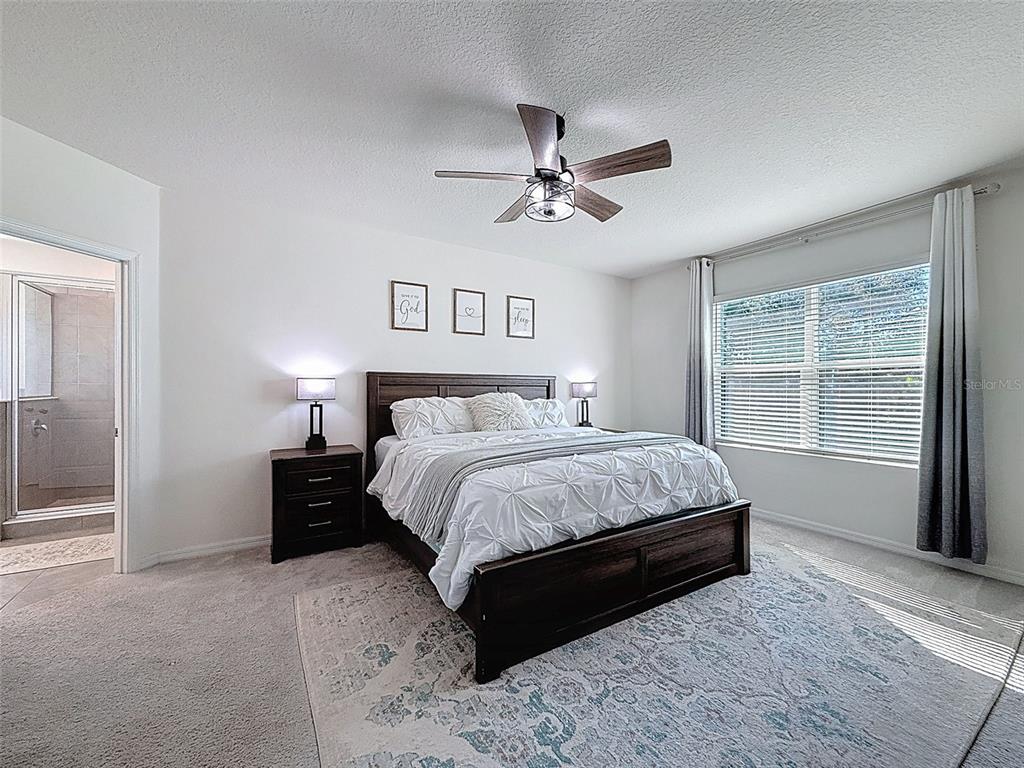 3797 Autumn Amber Dr Spring Hill Spring Hill, FL 34609 - Photo 22 of 44 a spacious bedroom with a bed and a window