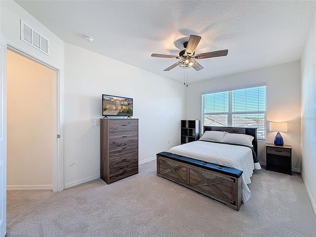 3797 Autumn Amber Dr Spring Hill Spring Hill, FL 34609 - Photo 28 of 44 a bedroom with a bed dresser and a window