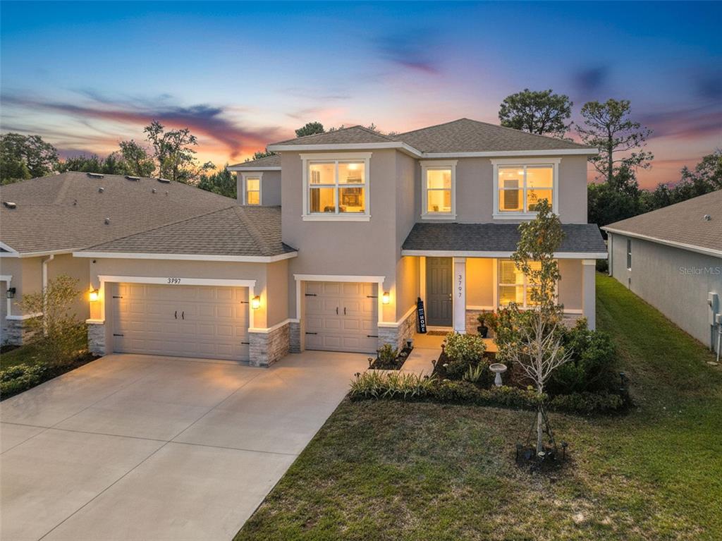 3797 Autumn Amber Dr Spring Hill Spring Hill, FL 34609 - Photo 3 of 44 a front view of a house with garden