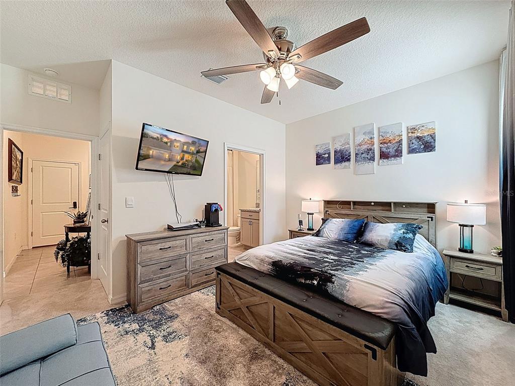 3797 Autumn Amber Dr Spring Hill Spring Hill, FL 34609 - Photo 31 of 44 a bedroom with a large bed and a flat screen tv