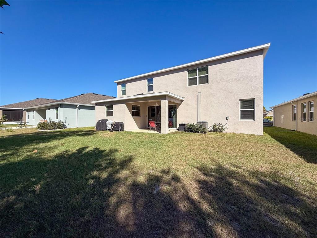 3797 Autumn Amber Dr Spring Hill Spring Hill, FL 34609 - Photo 33 of 44 a front view of a house with a yard