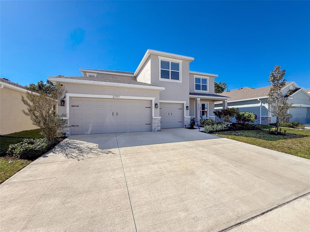 3797 Autumn Amber Dr Spring Hill Spring Hill, FL 34609 - Photo 4 of 44 a view of a white house with a yard
