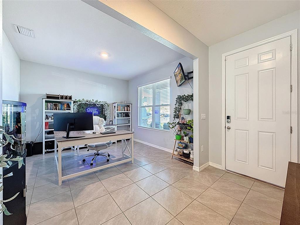 3797 Autumn Amber Dr Spring Hill Spring Hill, FL 34609 - Photo 5 of 44 a living room with furniture and a flat screen tv