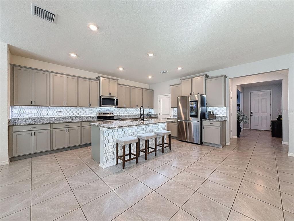 3797 Autumn Amber Dr Spring Hill Spring Hill, FL 34609 - Photo 9 of 44 a kitchen with a sink a counter top space stainless steel appliances and cabinets