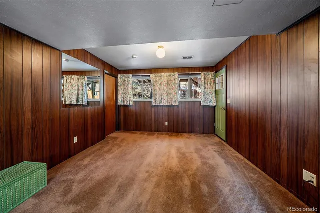 a playing room with furniture and a wooden floor