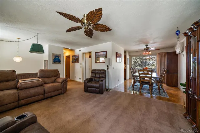 a dining room with furniture and wooden floor