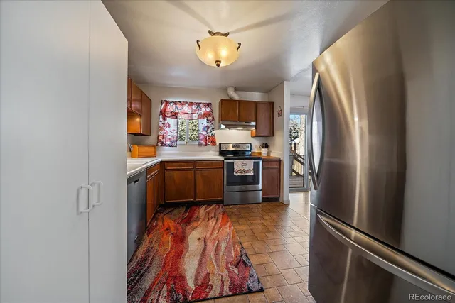 a kitchen with stainless steel appliances granite countertop a sink and cabinets