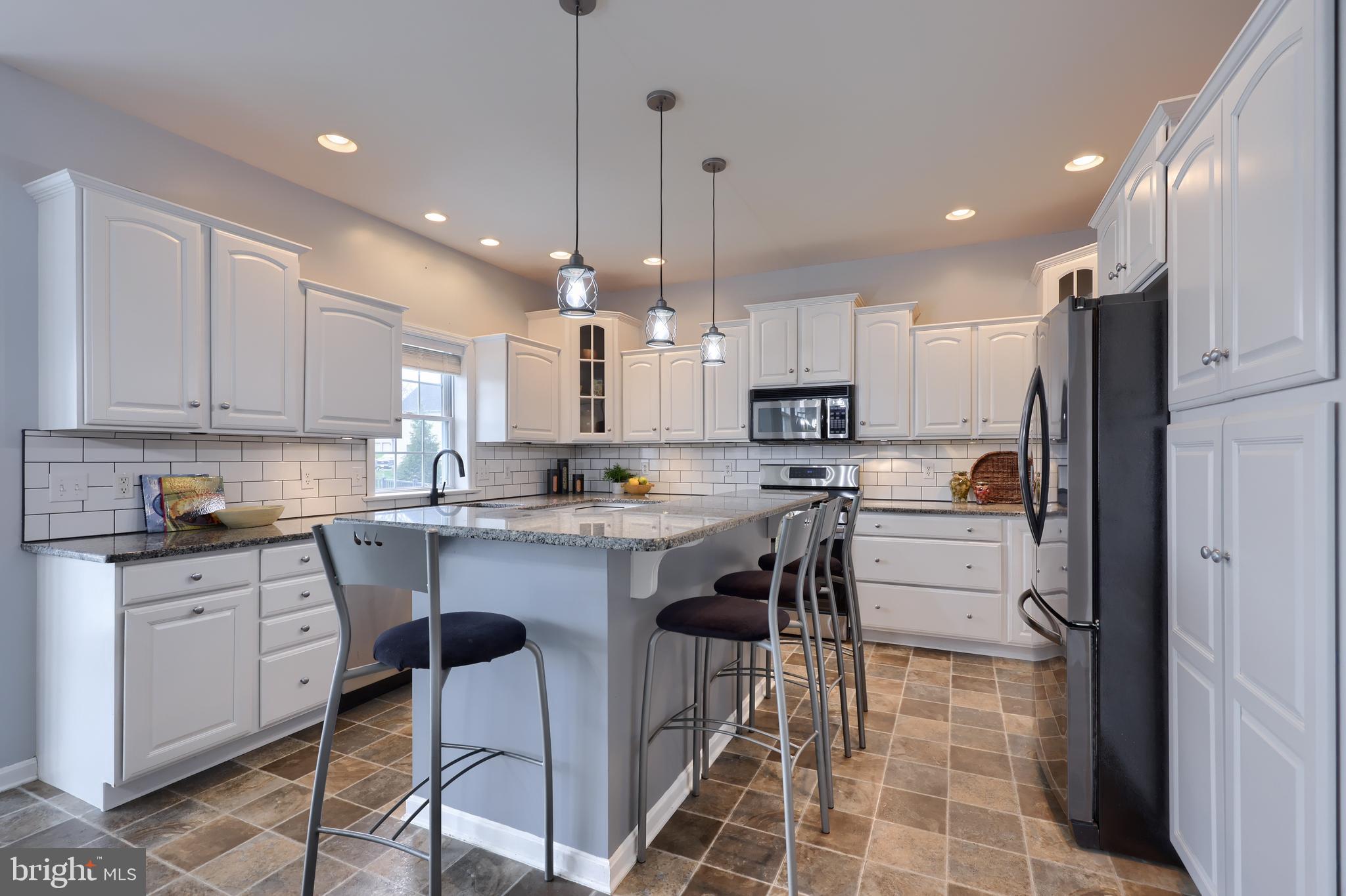 1860 Windy Hill Road Lancaster, PA 17602 - Photo 26 of 71 a kitchen with kitchen island granite countertop a sink cabinets and refrigerator