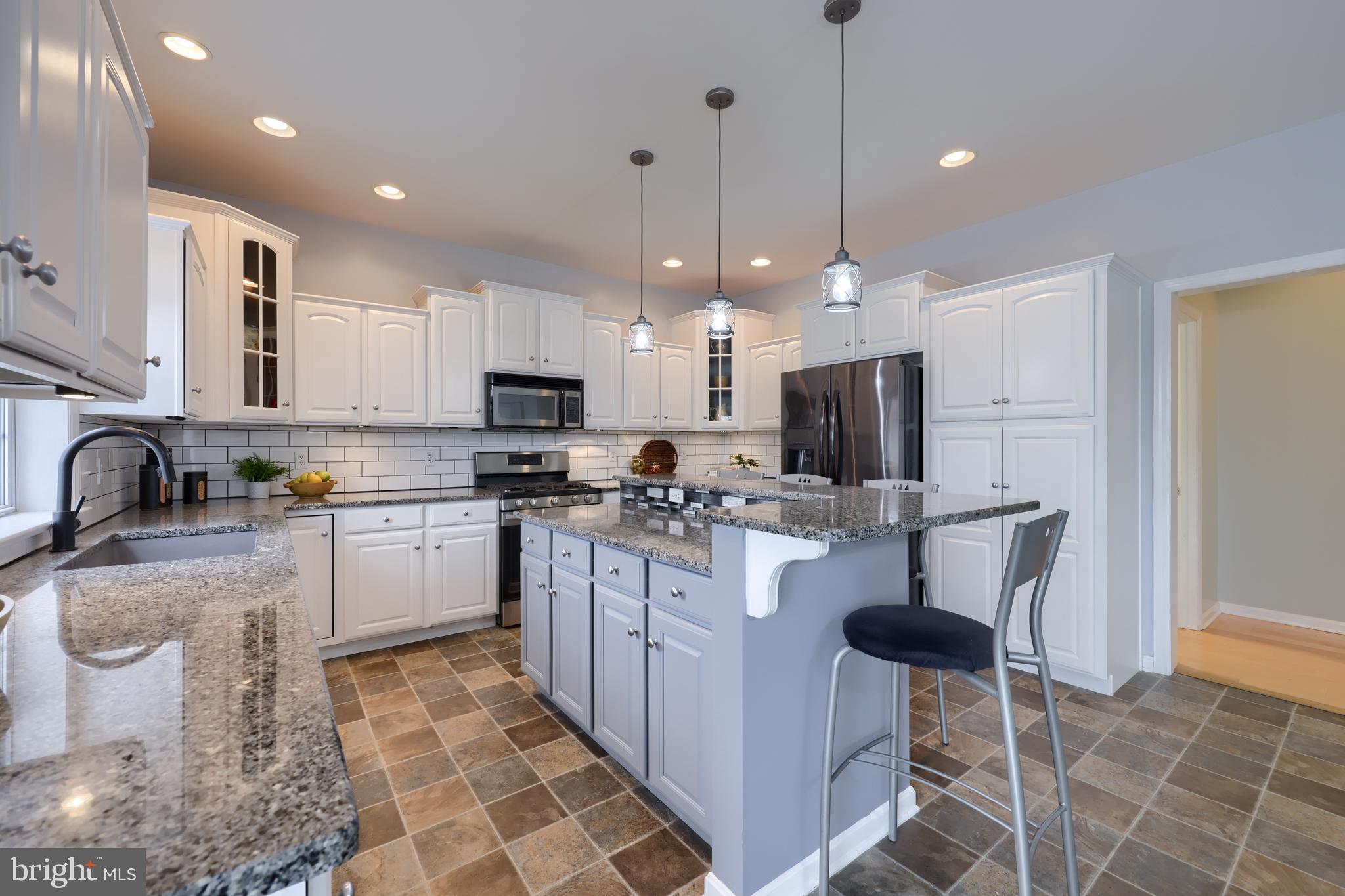 1860 Windy Hill Road Lancaster, PA 17602 - Photo 27 of 71 a kitchen with kitchen island granite countertop a sink a counter top space appliances and cabinets