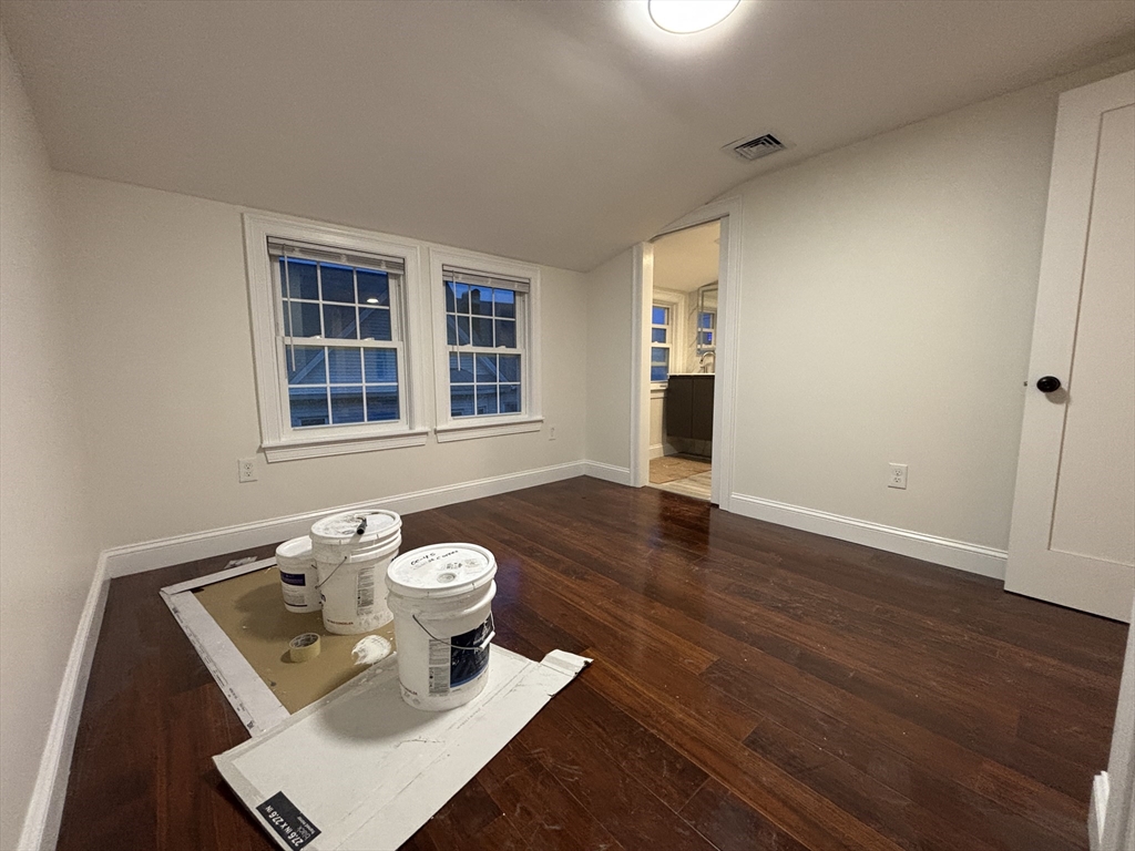 4 Appleton Street, Unit D Quincy, MA 02171 - Photo 6 of 12 a view of a workspace with wooden floor and a window