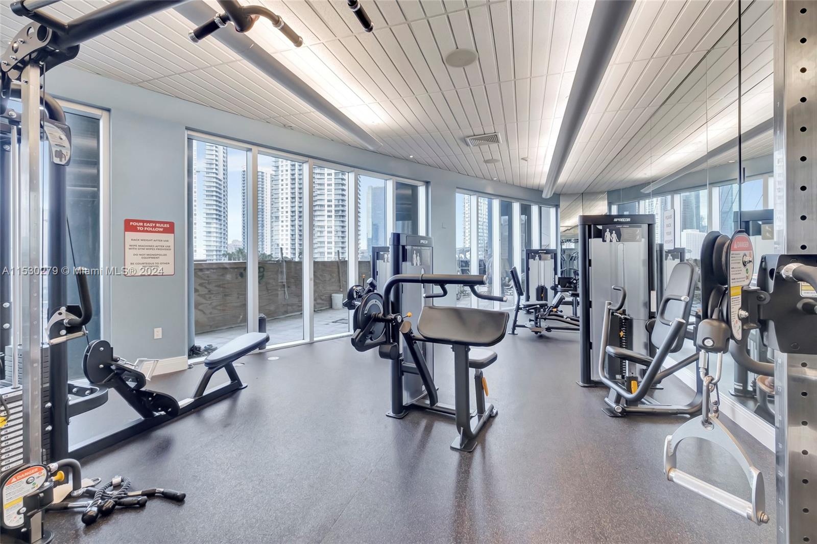a room with gym equipment and windows
