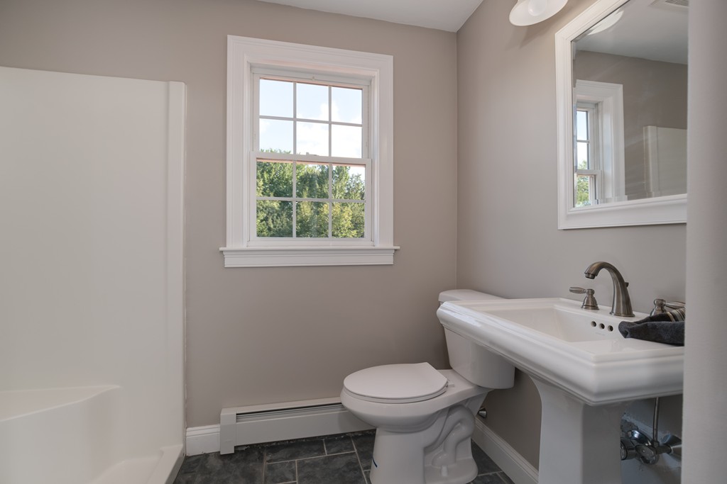 15 Winifreds Way Rutland, MA 01543 - Photo 12 of 30 a bathroom with a toilet sink and mirror
