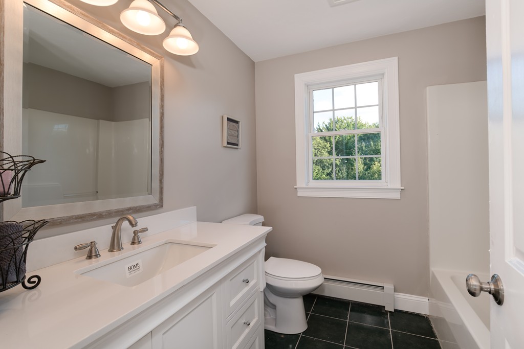 15 Winifreds Way Rutland, MA 01543 - Photo 17 of 30 a bathroom with a sink vanity granite toilet and a window