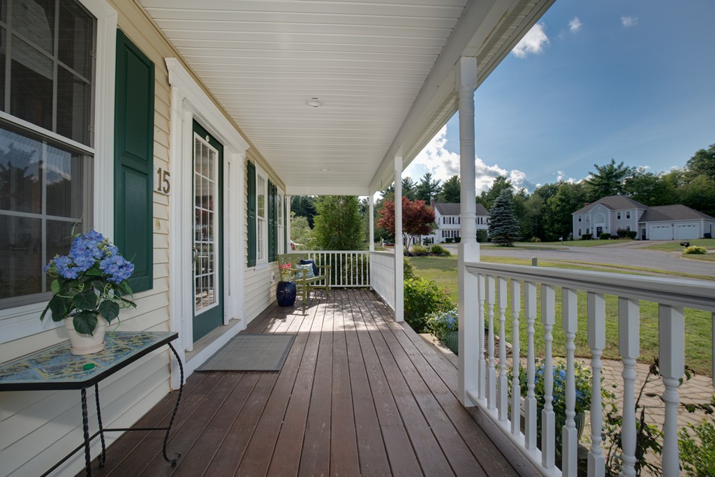 15 Winifreds Way Rutland, MA 01543 - Photo 3 of 30 a balcony with wooden floor table and chairs