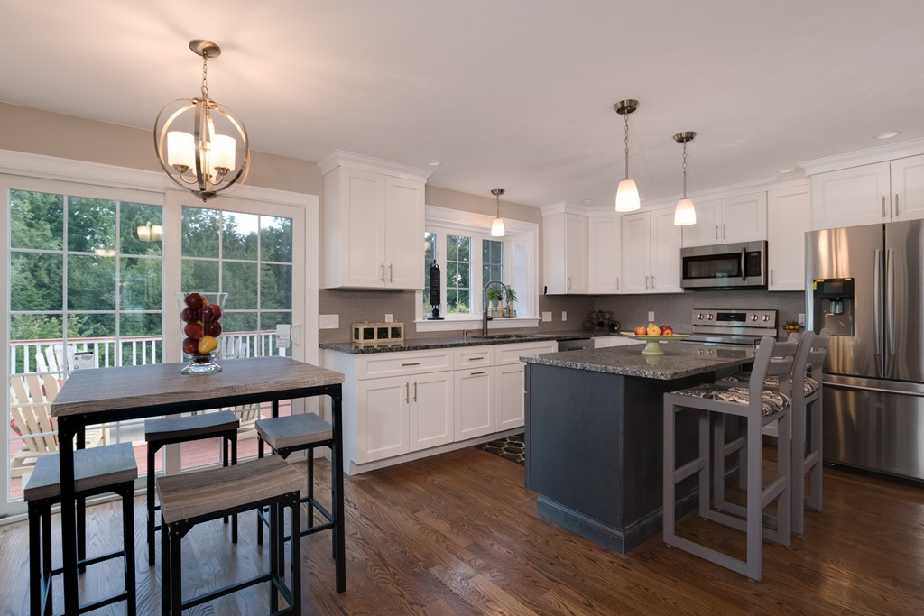 15 Winifreds Way Rutland, MA 01543 - Photo 5 of 30 a kitchen with stainless steel appliances granite countertop a stove top oven a refrigerator a sink and chairs