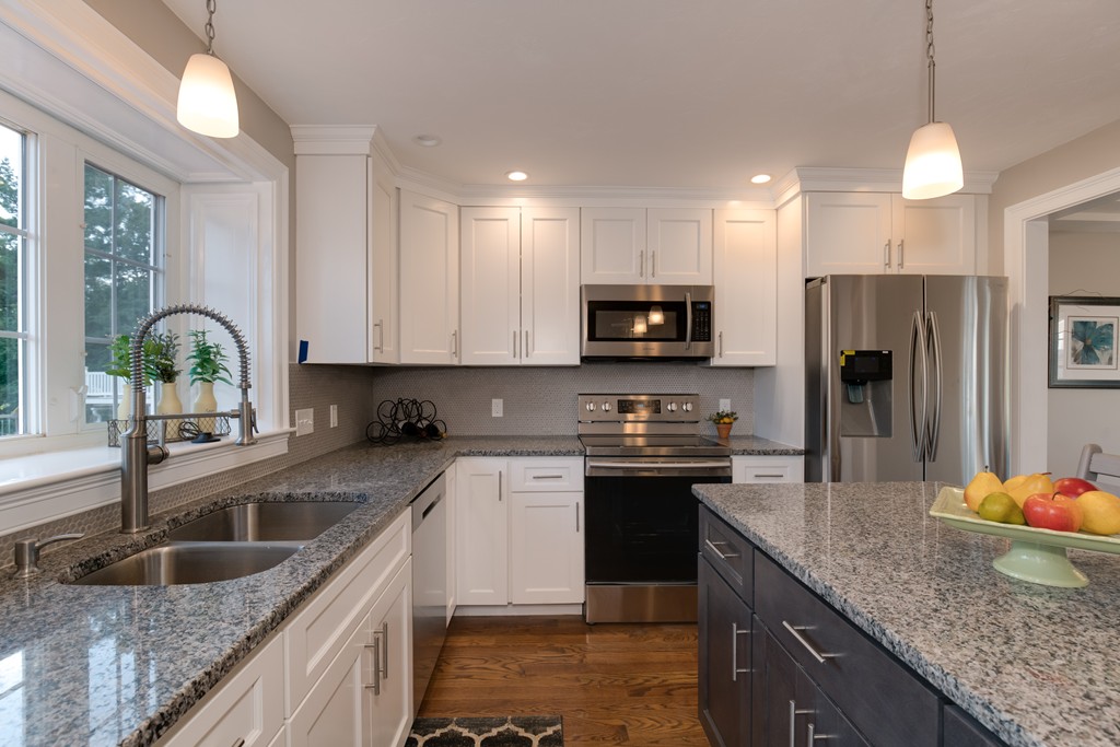 15 Winifreds Way Rutland, MA 01543 - Photo 7 of 30 a kitchen with stainless steel appliances granite countertop a sink a stove and a center island