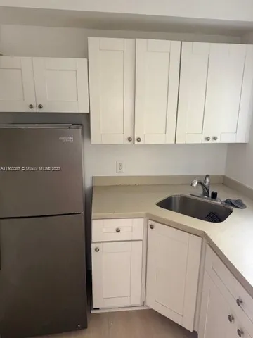 a kitchen with a sink and cabinets