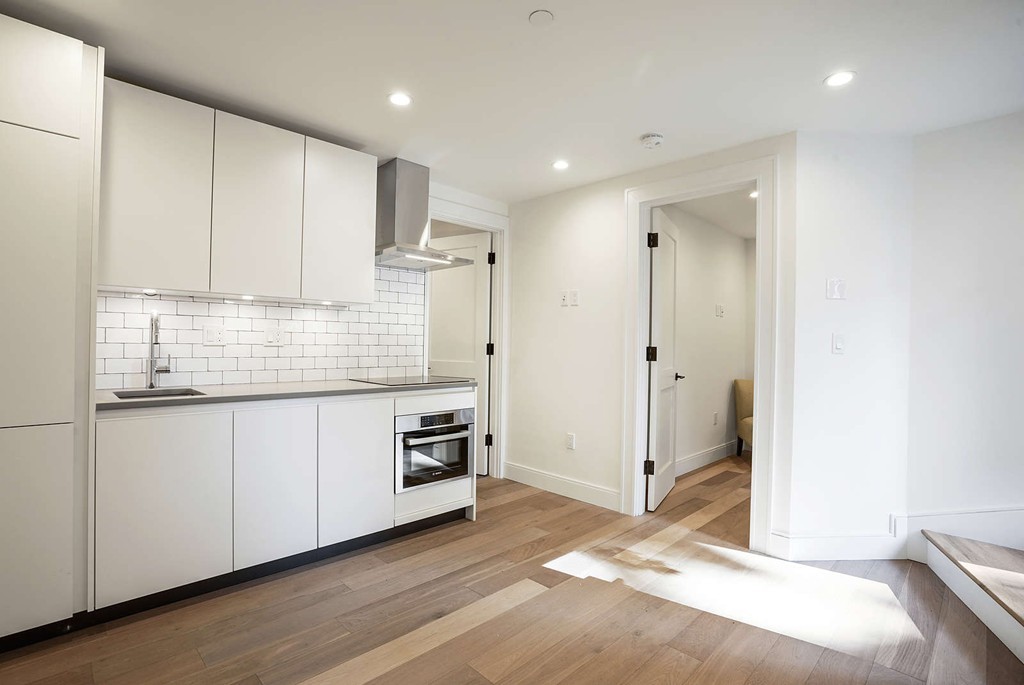 72 Beacon Street, Unit A Boston, MA 02108 - Photo 3 of 19 a kitchen with stainless steel appliances granite countertop a refrigerator and a sink