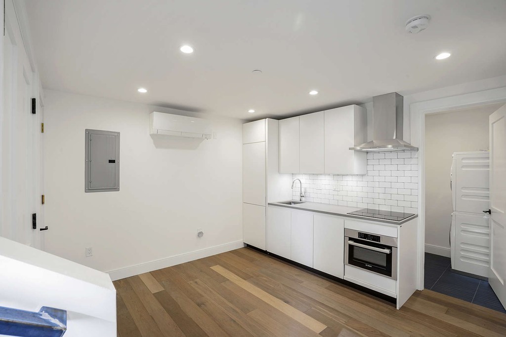 72 Beacon Street, Unit A Boston, MA 02108 - Photo 7 of 19 a kitchen with stainless steel appliances granite countertop a stove and a refrigerator